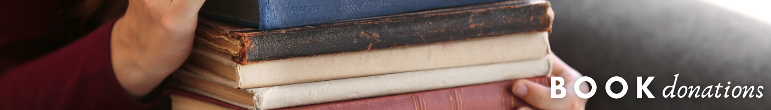 Book Donations - Photo of person carrying books.