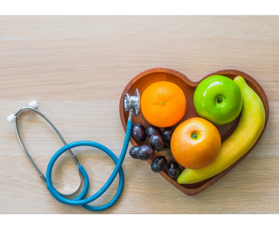A photo of healthy foods and a stethoscope arranged in the shape of a heart.
